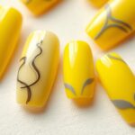 Paznokcie żółte z szarym w różnych stylizacjach ułożone na jasnym tle